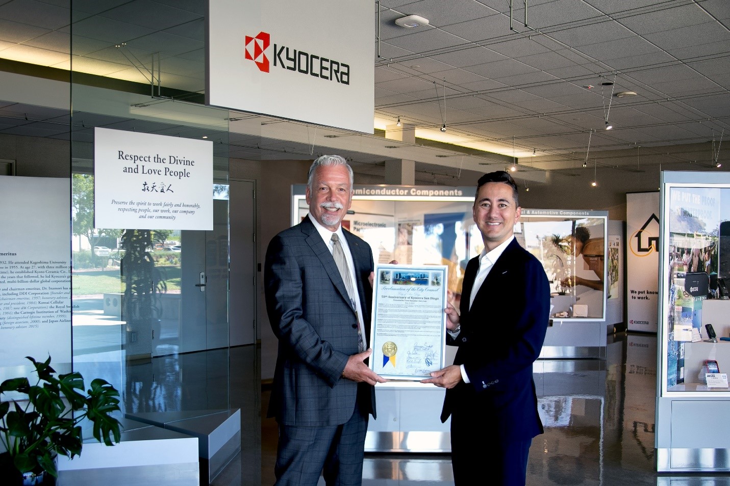 Kyocera International, Inc. President Bob Whisler (left) receives City of San Diego Proclamation from Councilmember Chris Cate honoring the company’s 50 years of local manufacturing.